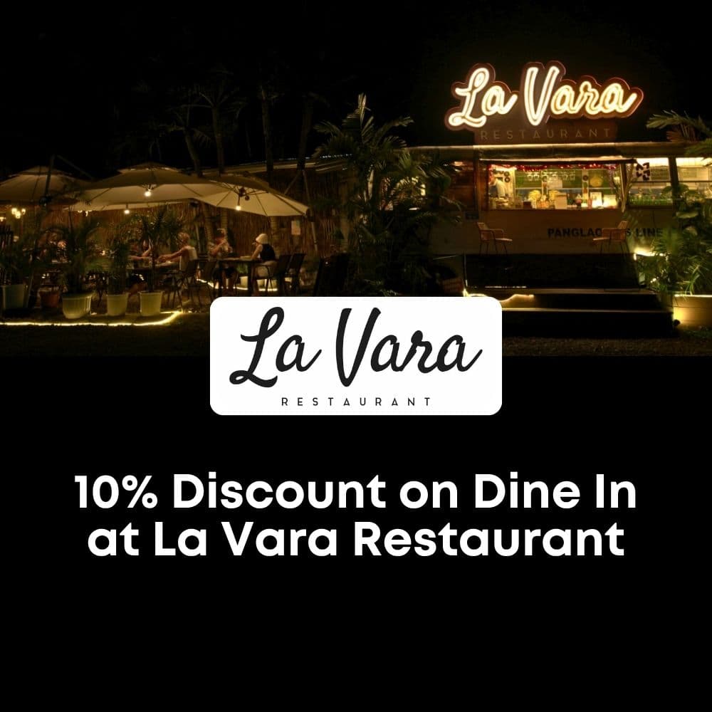 La Vara Restaurant exterior at night with outdoor seating and warm lights