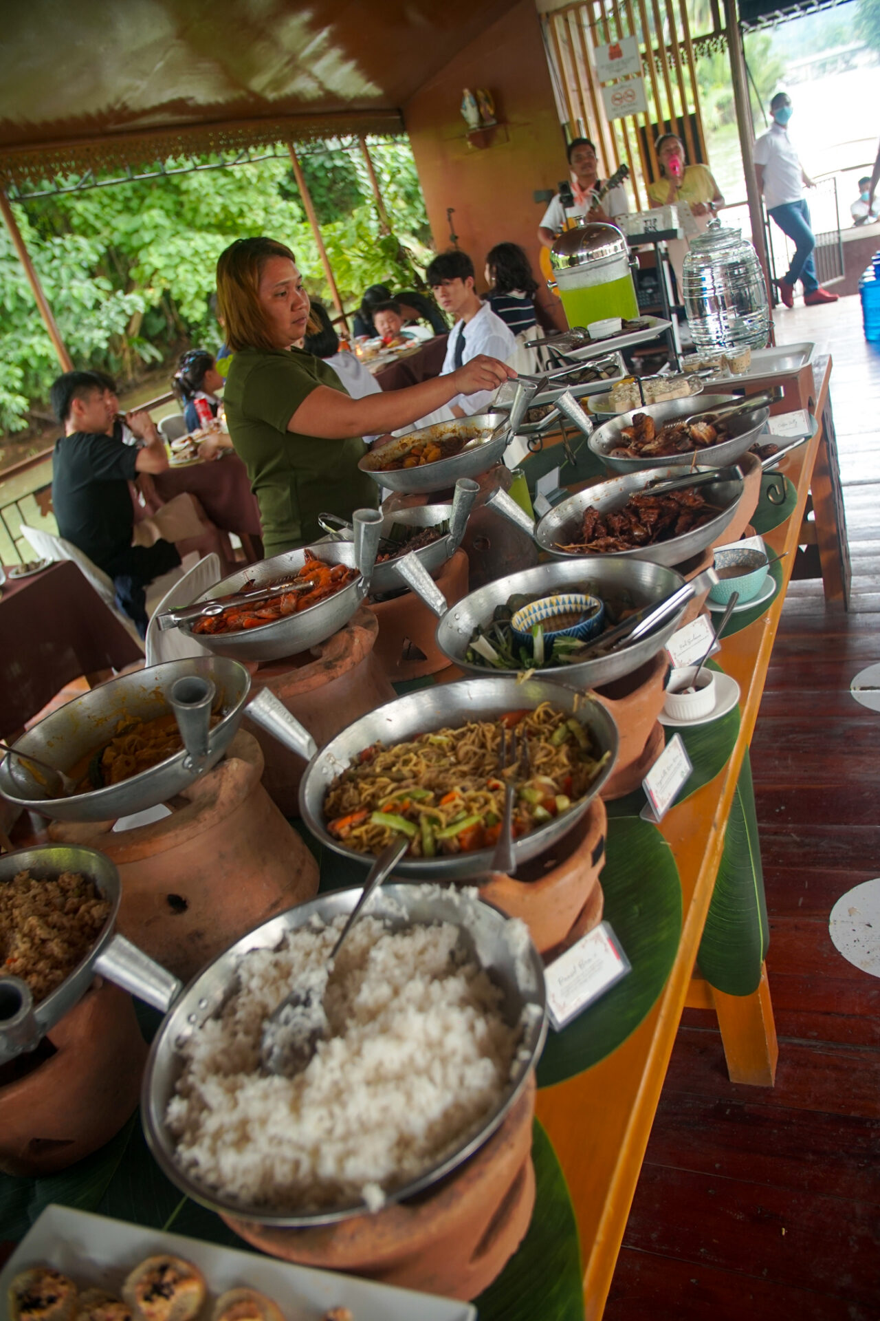 Traditional Filipino buffet served aboard a floating restaurant cruising along the Loboc River in Bohol.