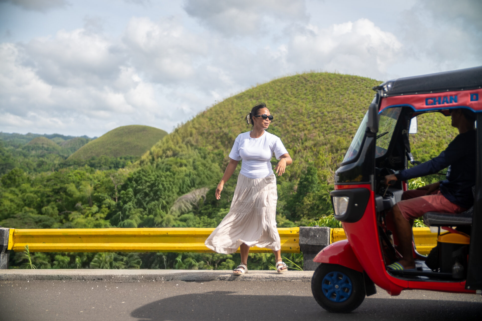 Visitor admiring the panoramic view of the Chocolate Hills from the viewing deck in Carmen, Bohol.