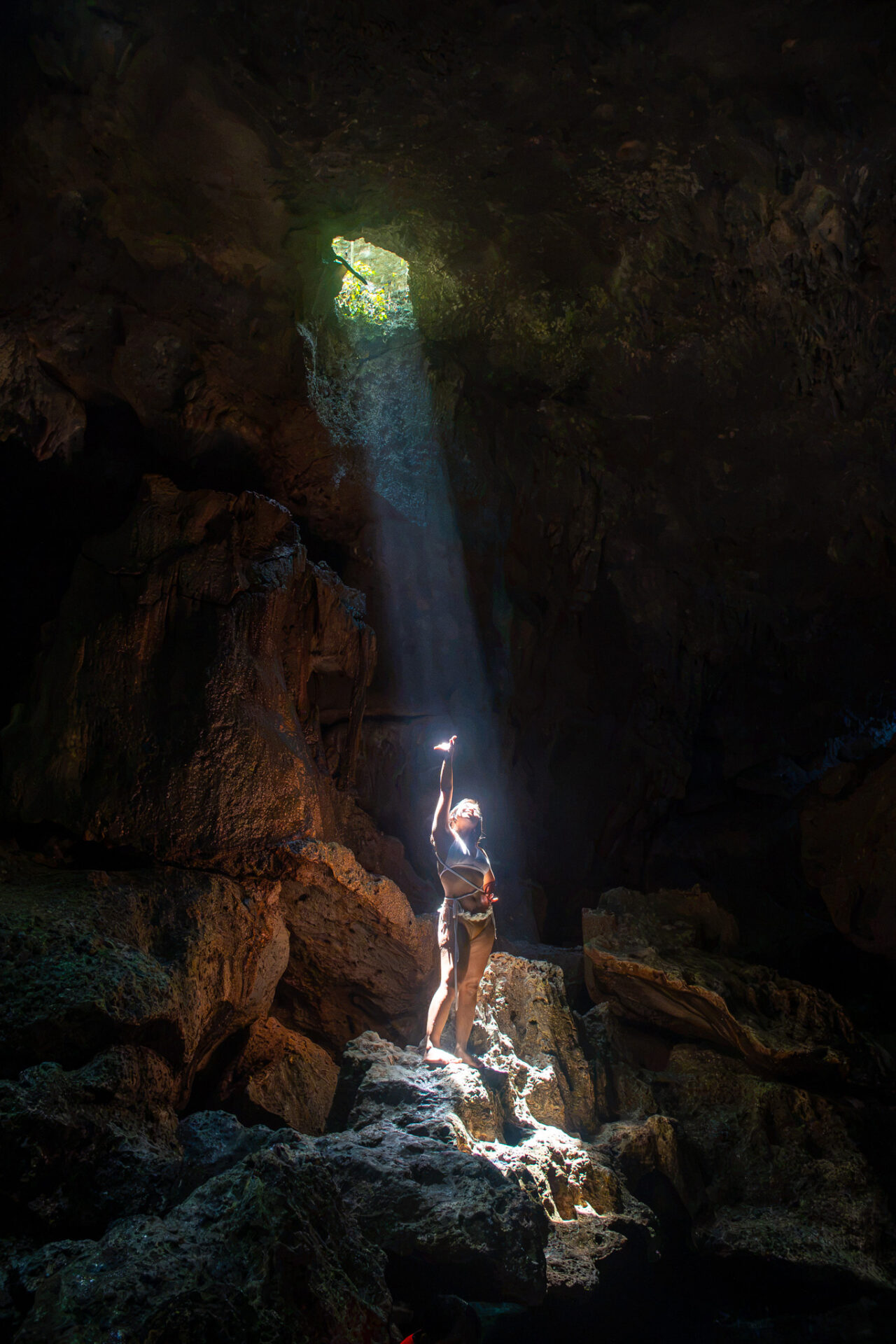 A dramatic beam of sunlight enters Hinagdanan Cave, illuminating the limestone chamber in Panglao, Bohol.