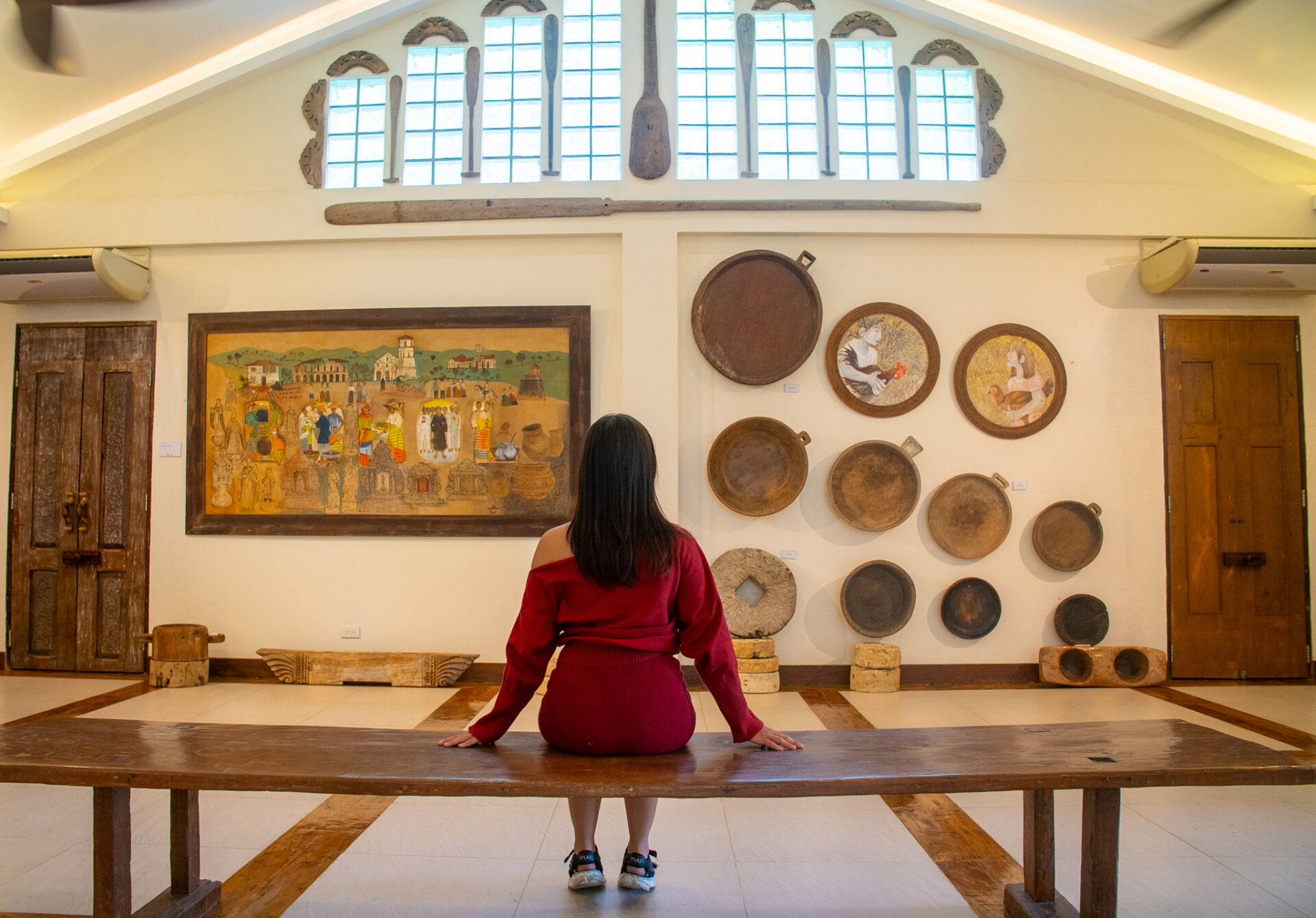 Visitor admiring local artwork and cultural exhibits inside the Amarela Resort Art Gallery in Panglao, Bohol.