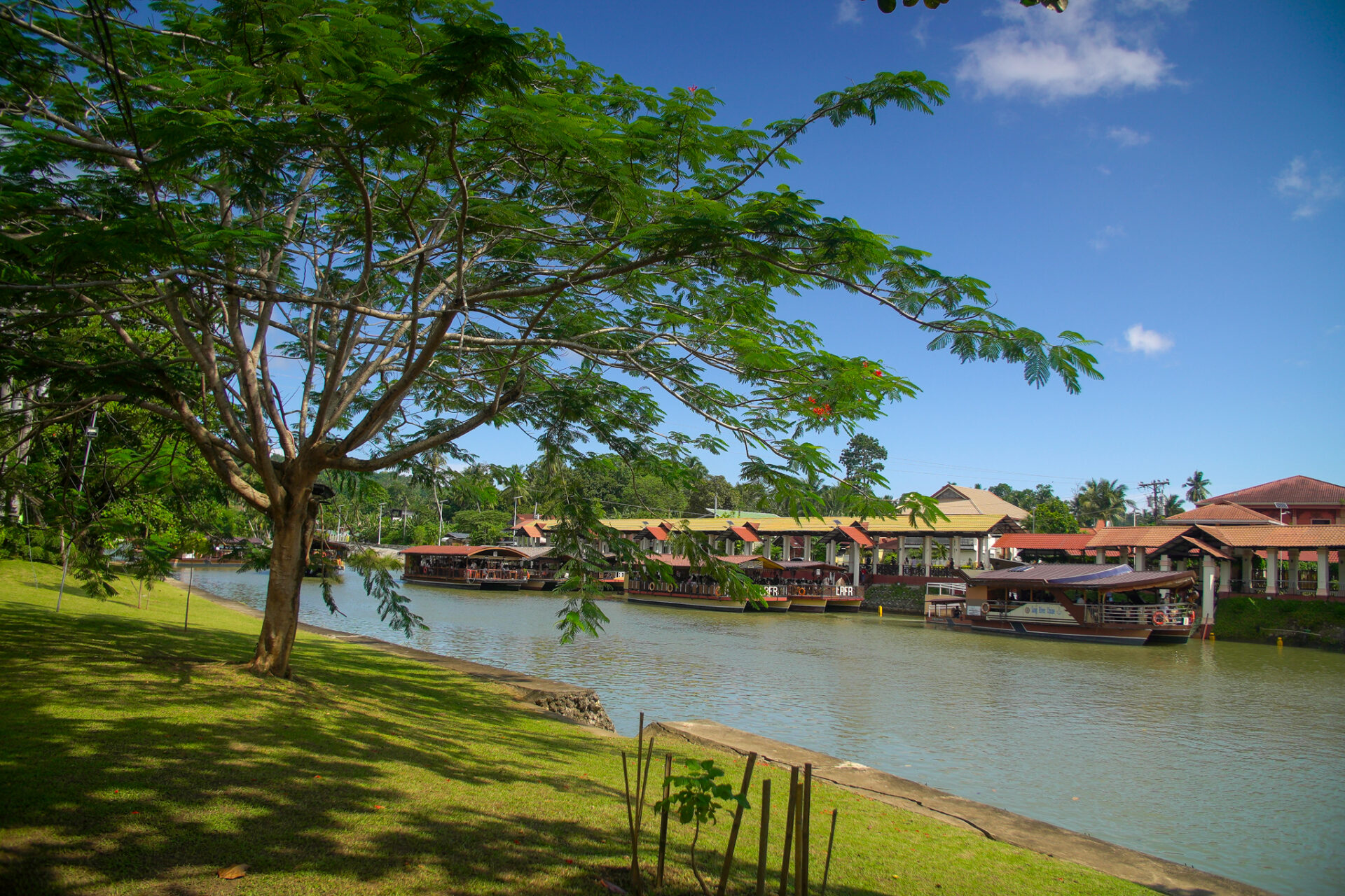 Floating restaurants cruising along the peaceful Loboc River surrounded by lush tropical landscapes in Bohol.