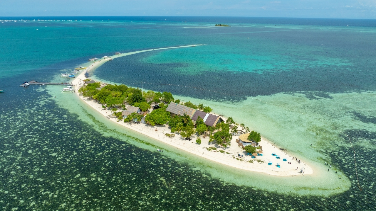 Aerial view of Virgin Island Sandbar with crystal-clear turquoise waters and a long white sandbar in Bohol Island Geopark.